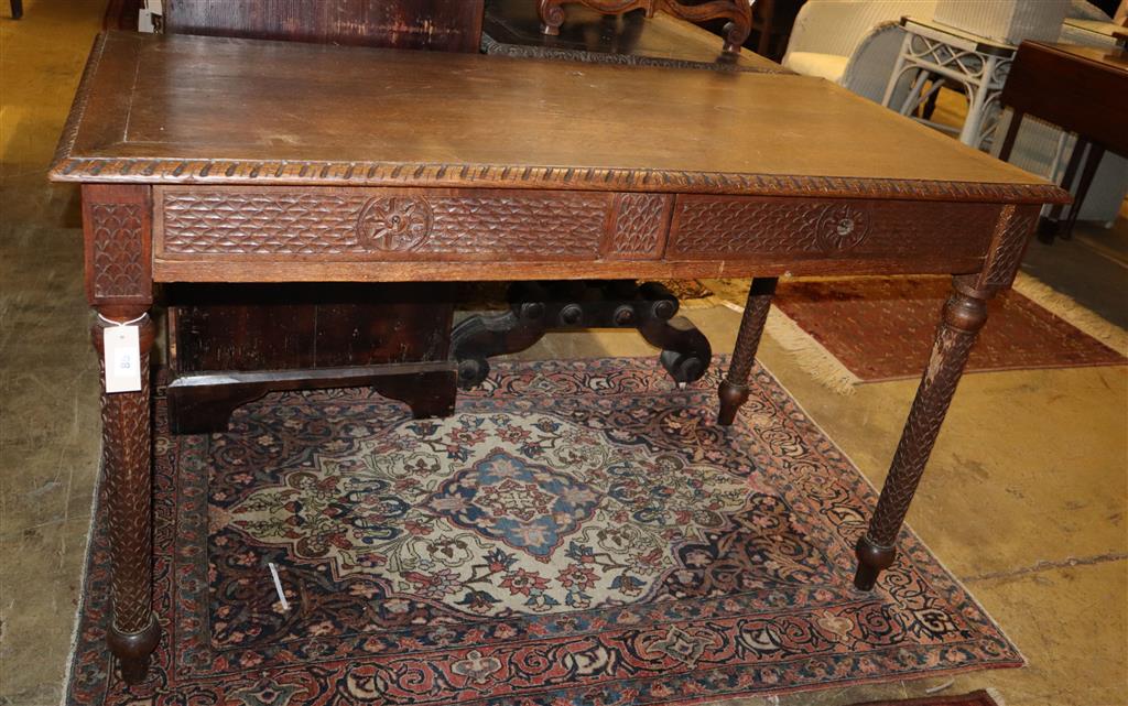 A 19th century chip carved oak two drawer writing table, width 128cm, depth 62cm, height 75cm